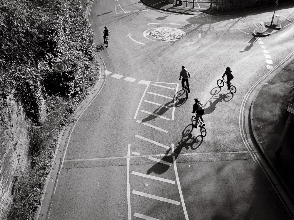 Children on bikes, long shadows