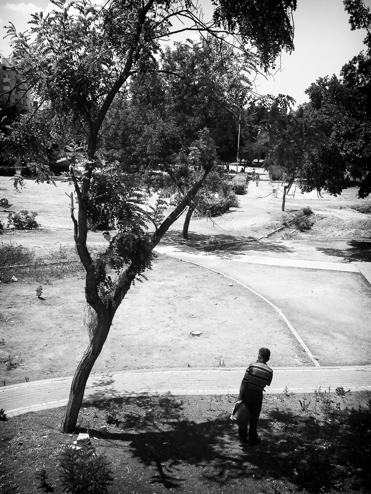 Man finds shade in 43 degree heat in Nicosia, Cyprus